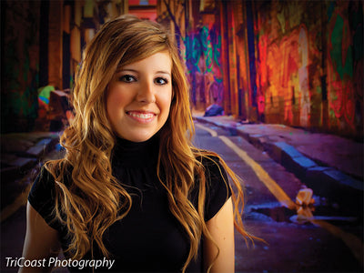 Backdrop featuring long alley stretch framed by tall buildings and debris.
