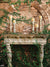 Ancient Stone Wall Mantle Photography Backdrop - Photography backdrop featuring an ancient, ivy-covered stone wall with a beautifully carved stone mantle adorned with vintage candle holders and glowing candles.