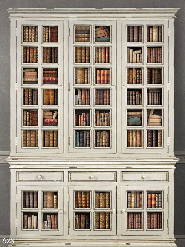 Antique White Bookshelf Photography Backdrop - An antique white bookshelf photography backdrop featuring glass-paned doors filled with classic books in various colors.