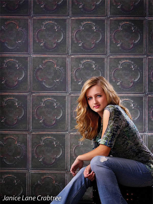 Decorative tile backdrop with historic design and dark green tones.