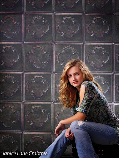 Decorative tile backdrop with historic design and dark green tones.