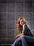 Decorative tile backdrop with historic design and dark green tones.