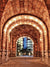 Architectural Urban Archway Photography Backdrop - Warmly lit stone archway leading to a modern glass building with cool blue lights in an urban setting.