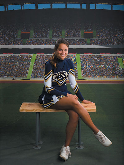 Bright turf and stadium tunnel view for sports-themed studio portraits.