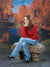 Scenic fall setting featuring golden and red trees surrounding a peaceful river bend.