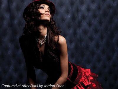 Elegant black tufted photography backdrop with diamond pattern for upscale portraits.