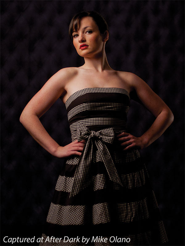 High-end black photography backdrop with detailed tufting.