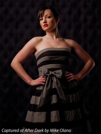 High-end black photography backdrop with detailed tufting.