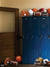 Blue Sports Locker Room Photography Backdrop - Blue lockers with various sports equipment including football helmets, basketballs, and gloves for sports-themed photography.