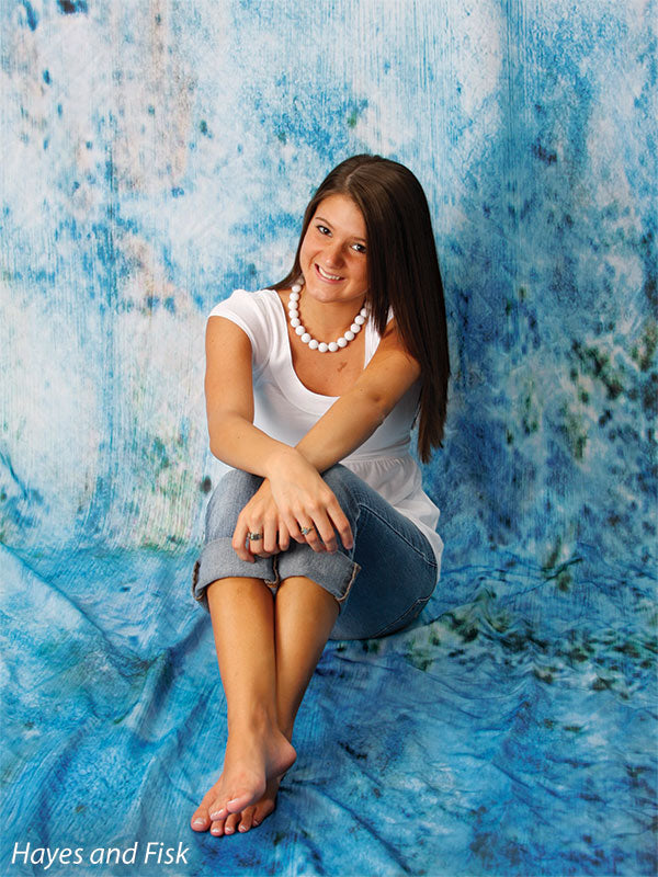 Lightly textured photography backdrop with faded color variation and depth.