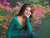 Colorful blooming bushes and dense greenery surround a soft grassy area.
