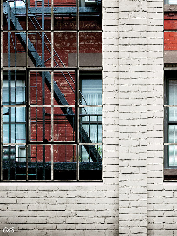 Brick Wall with Fire Escape Window Backdrop - Photography backdrop of a red brick wall with large industrial windows and a black wrought-iron fire escape.