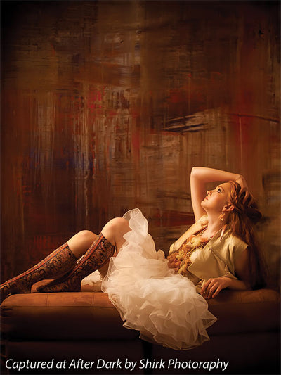 Backdrop resembling burned wood with hints of bold color.