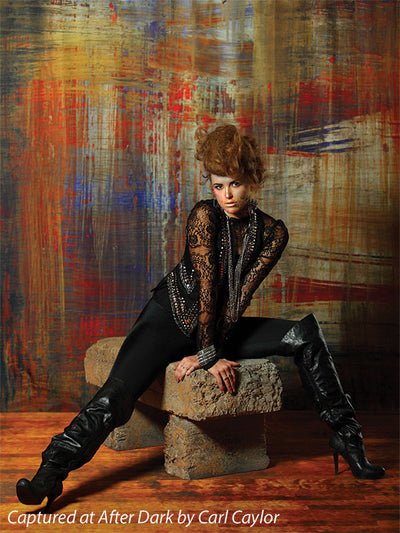 Painterly backdrop in golden ochre and layered rust tones.