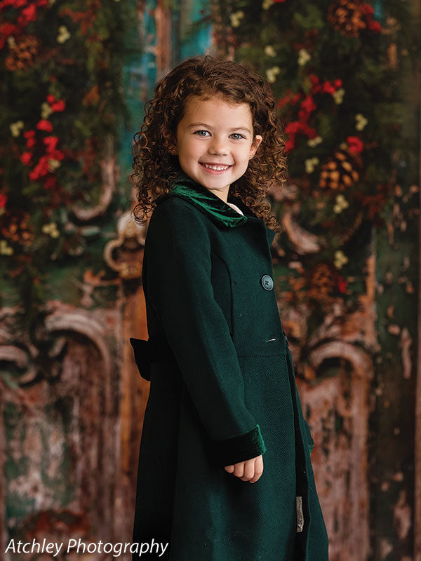 Little girl in front of holiday door