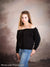 Teen girl poses in front of soft pink and taupe clouded sky backdrop with subtle florals, ideal for senior portraits and styled studio photography.
