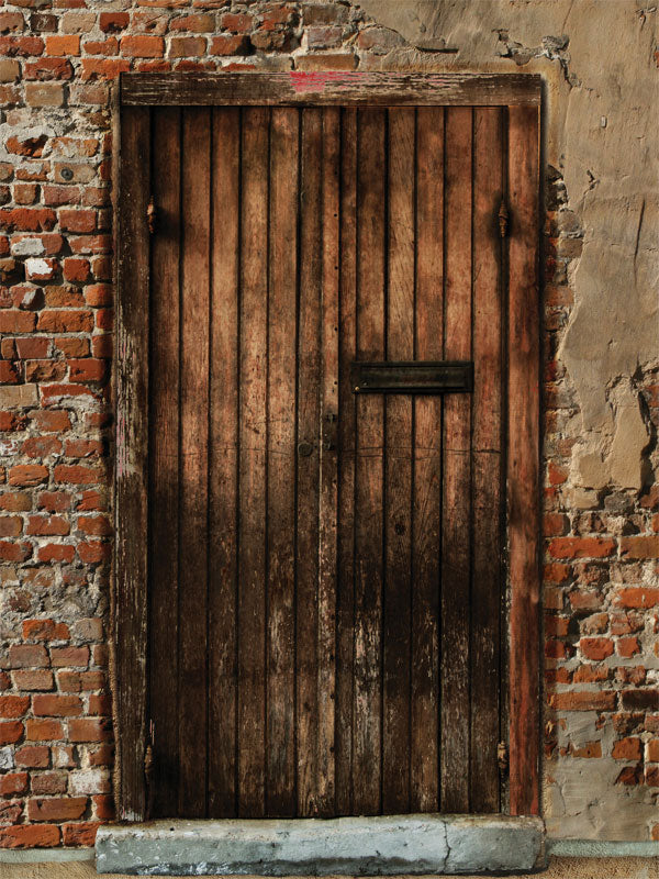 Rustic wood door photo backdrop with distressed brick and plaster.
