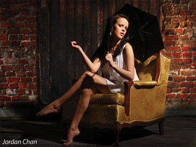 Studio backdrop with aged wooden door and cracked plaster.