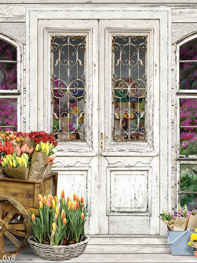 Charming Florist Shop Photography Backdrop - Charming florist shop photography backdrop with a rustic white door, ornate ironwork, and vibrant flowers.