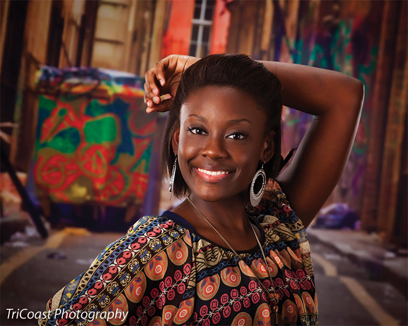 Backdrop focusing on the direct path between tall, graffiti-covered buildings.