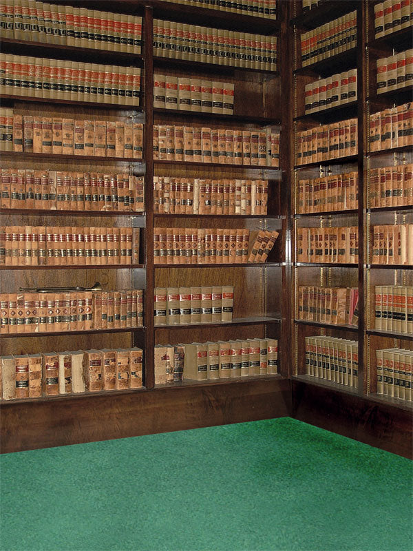 A sophisticated photography backdrop featuring towering wooden bookshelves filled with antique books in a study-like setting.