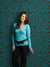 Ornate vintage damask design with bold teal-on-brown contrast.