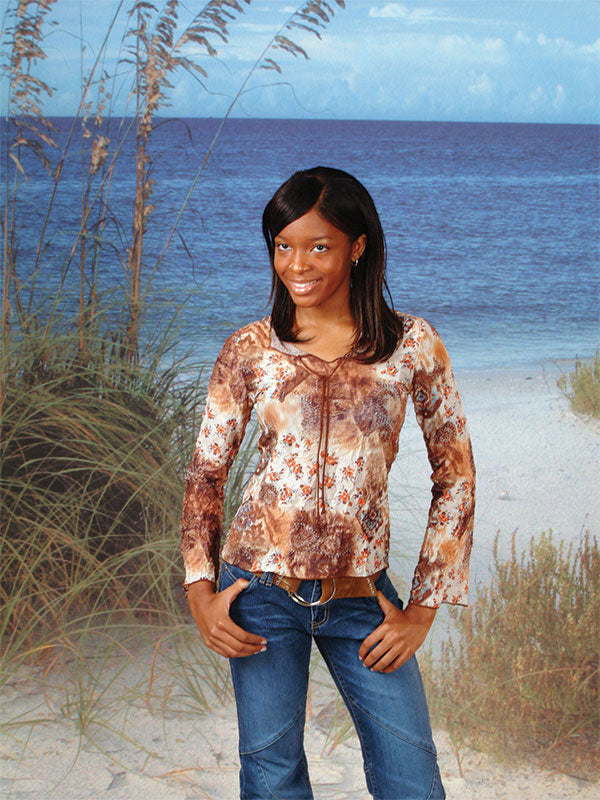 A beach-inspired backdrop with a scenic ocean horizon, gently rolling waves, and lush coastal grass for a realistic beach setting.