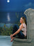 A peaceful beach backdrop with a glowing moon and deep blue ocean horizon, ideal for moody portrait sessions.