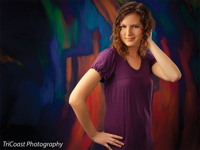 Color bursts flow across this painted backdrop in expressive motion.
