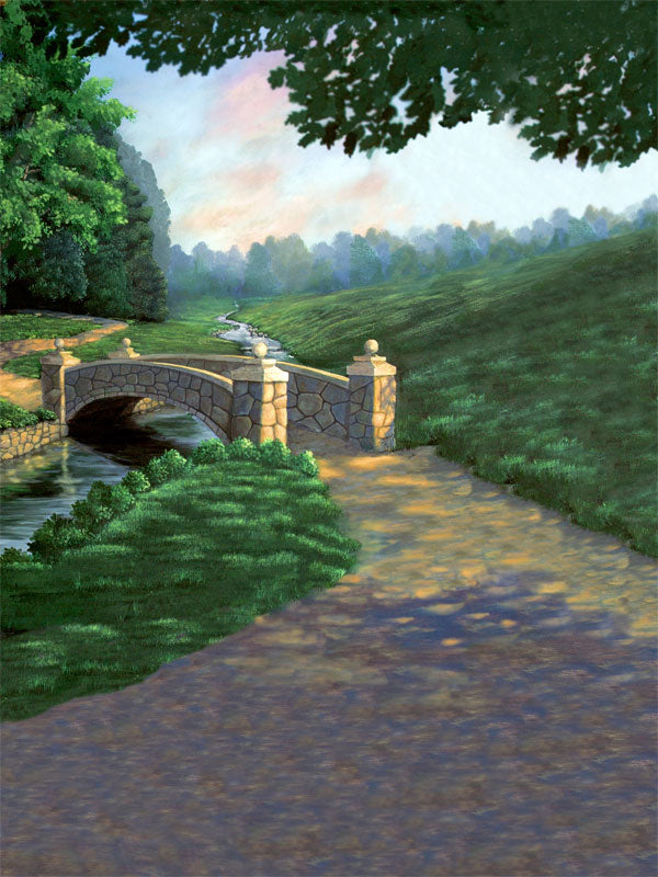 A picturesque photography backdrop featuring a stone bridge over a stream with a path winding through grassy hills.
