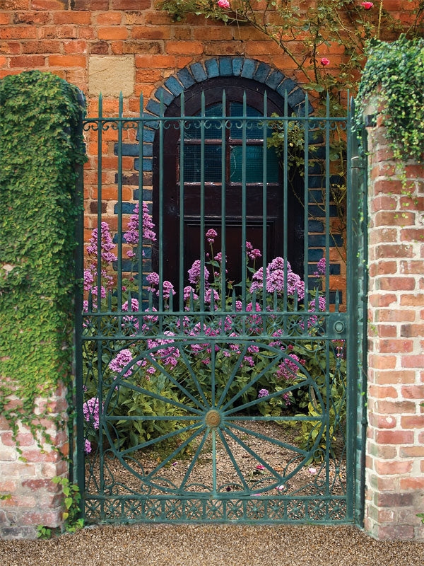 Photography backdrop of a brick wall adorned with ivy and a floral arch, creating a charming and romantic scene for photoshoots.