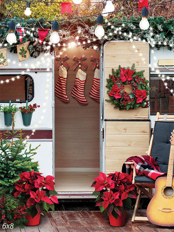 Cozy Christmas Camper Photography Backdrop - Photography backdrop featuring a cozy holiday camper scene with Christmas decorations, twinkling lights, and poinsettias.