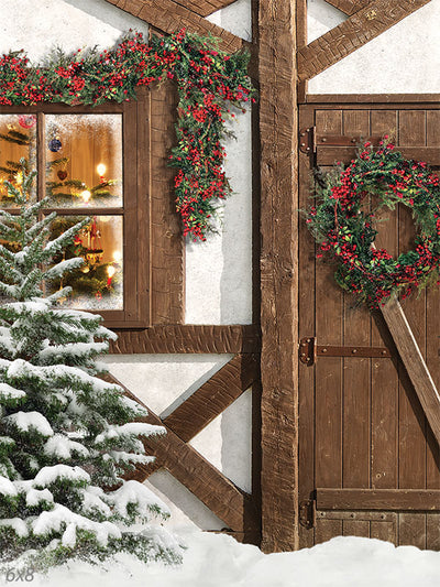 Cozy Christmas Cottage Photography Backdrop - Photography backdrop featuring a snow-covered Christmas cottage with a warmly lit window, holiday decorations, and a wooden door with a wreath.