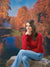Warm, sunlit autumn park scene with vibrant foliage and grassy foreground.