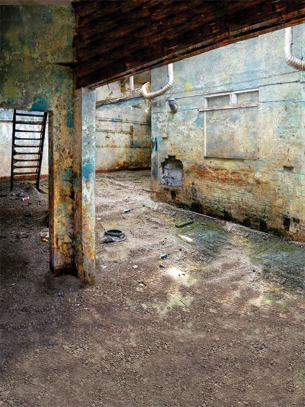 Backdrop with gritty concrete floor and decaying industrial walls.