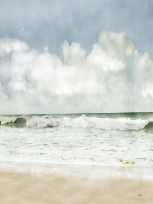 A soft ocean backdrop with dreamy waves and fluffy clouds for fantasy photo shoots.
