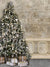 Elegant Christmas Tree with Vintage Wall Photography Backdrop - An elegant Christmas tree with silver and gold decorations placed beside a vintage wall, perfect for festive photography backdrops.
