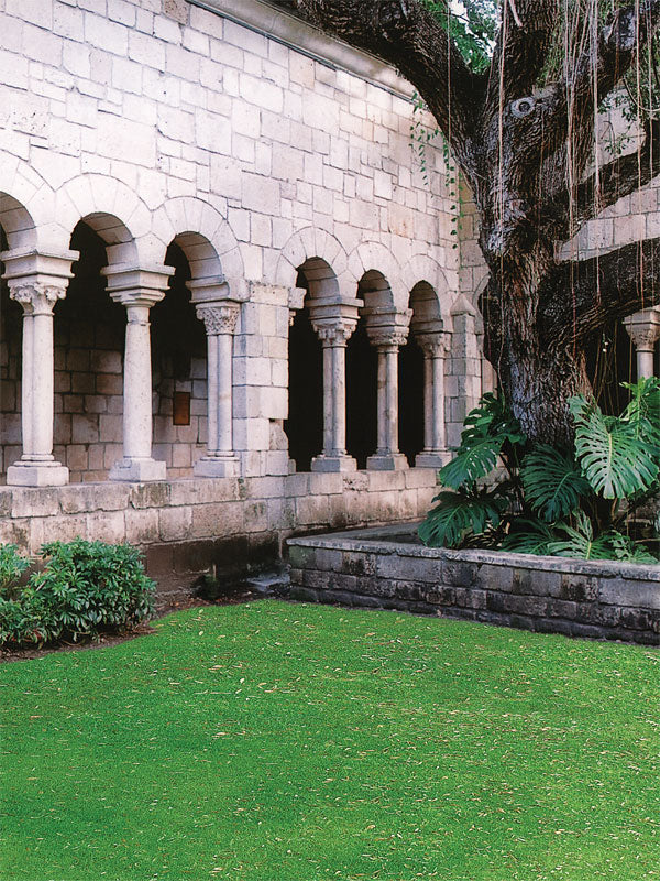 A classic photography backdrop featuring historic stone columns, arched walkways, and lush garden greenery.