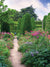 Enchanted Garden Path Photography Backdrop - Photography backdrop featuring a vibrant garden path with blooming flowers and tall green shrubs, perfect for nature-inspired photoshoots.