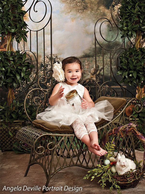 An atmospheric scene featuring angelic statuary and overgrown greenery for a classic fine art look.