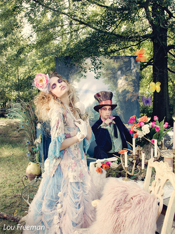 Princess forest themed backdrop being used outdoors with Alice and Wonderland themed photoshoot 