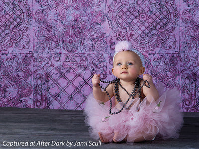 Soft vintage-style pink studio photography backdrop.
