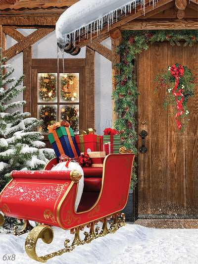 Festive Sleigh by the Cottage Door Photography Backdrop - Photography backdrop featuring a festive sleigh and cottage door decorated with holiday wreaths and garlands in a snowy scene.