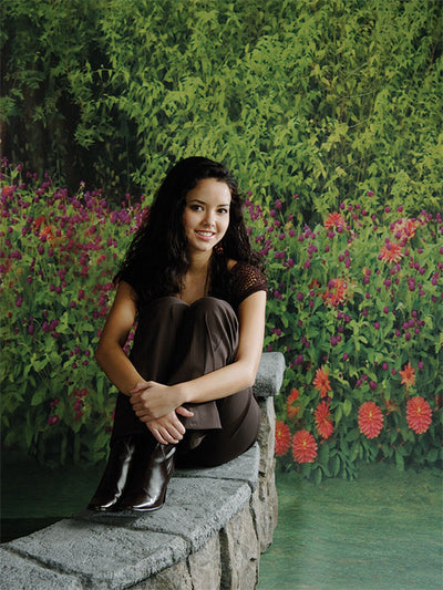 Studio backdrop featuring vibrant flower hedge with soft background path.