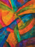 Bold abstract swirl of textured color blocks in orange, green, and blue.
