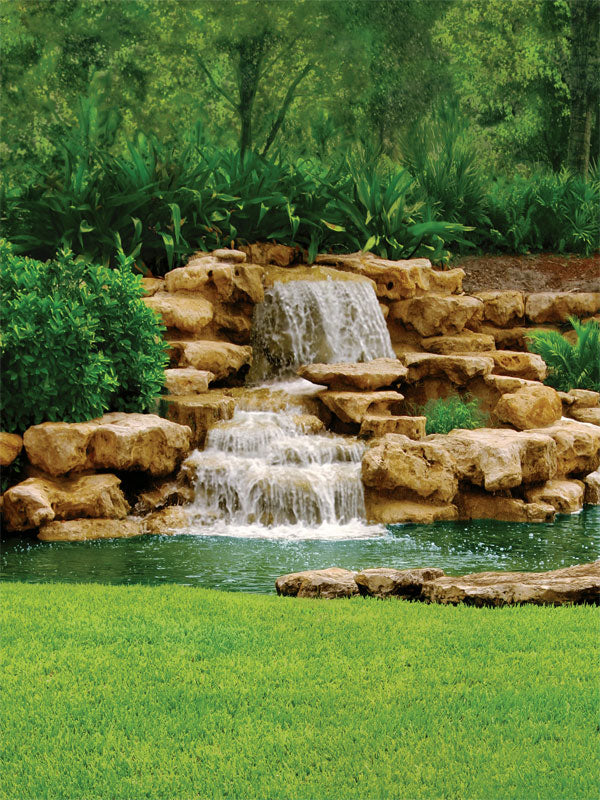 A stunning photography backdrop featuring a cascading waterfall over layered rocks, surrounded by lush green foliage—perfect for nature, wedding, and relaxation shoots.