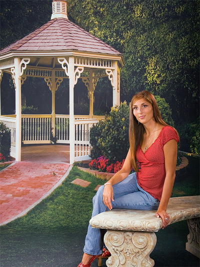 Lush green lawn with red and pink flower beds in a formal park setting.