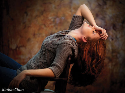Textured studio background in burnt orange, ochre, and sienna tones.
