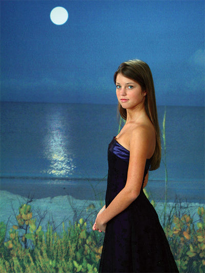 A scenic nighttime ocean backdrop with a full moon casting light over the water, creating a serene and tranquil setting.