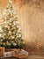 Golden Christmas Tree Glow Photography Backdrop - Photography backdrop featuring a glowing Christmas tree with golden fairy lights and white and gold ornaments, set against a warm, textured golden background.